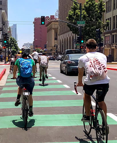 People riding bikes on a crosswalk