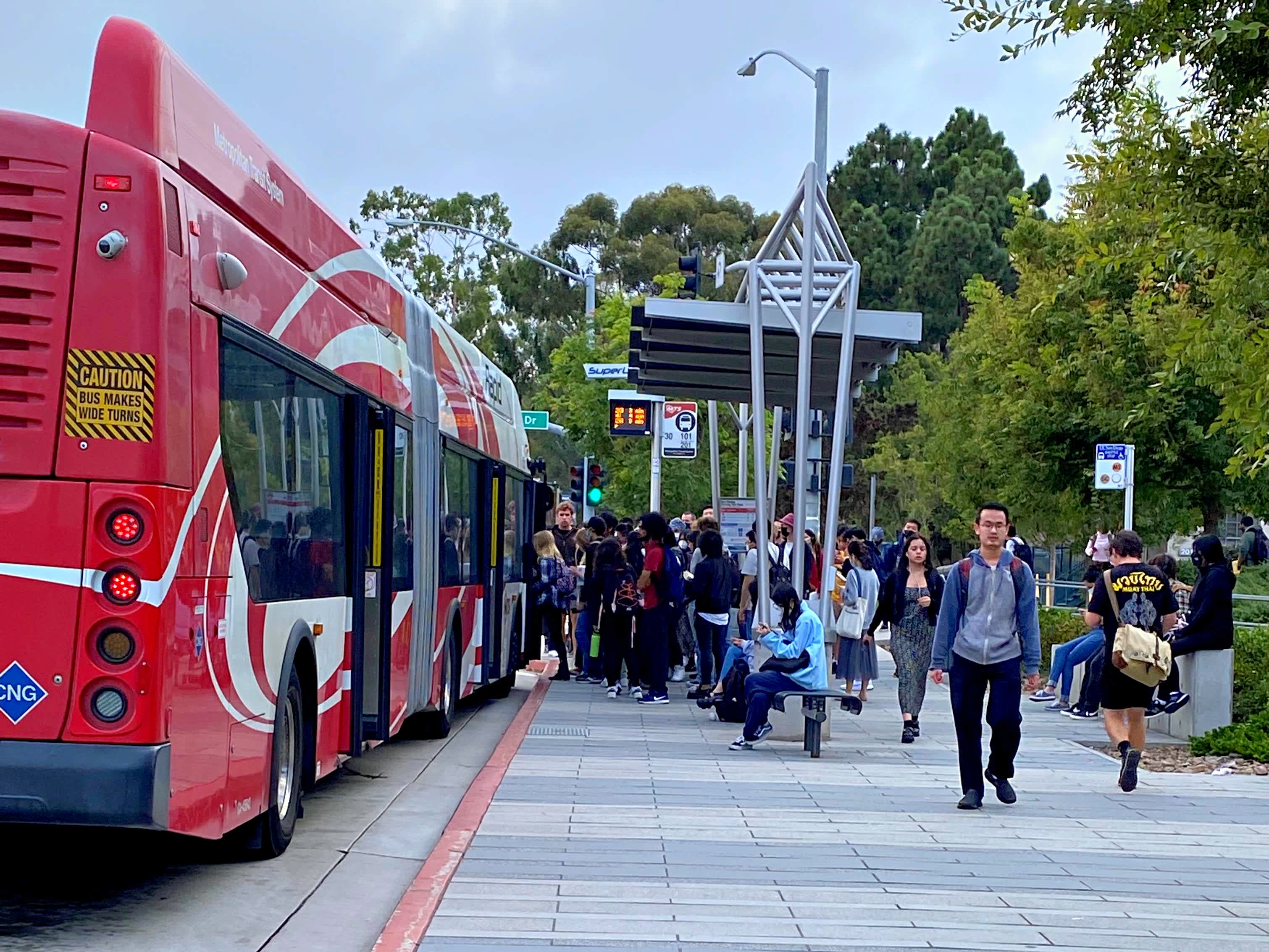 Bus riders at a SuperLoop stop