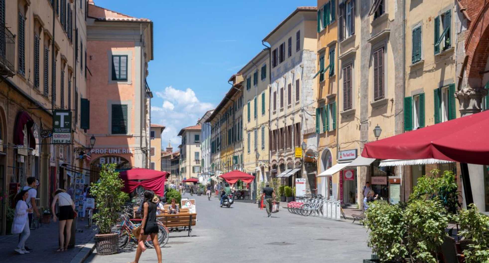 city,urban area,town,road surface,street,public space,pedestrian,neighbourhood,road,summer,urban design,thoroughfare,vacation,mixed-use,bicycle,travel,bicycle tire,bicycle wheel,lane,umbrella,sidewalk,holiday,bicycle frame,walking,bicycles--equipment and supplies