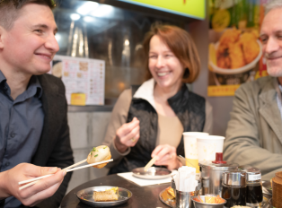 Tourists enjoying Traditonal Japanese food in Japan