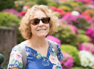 Happy tourist in one of the beautiful Japanese garden i