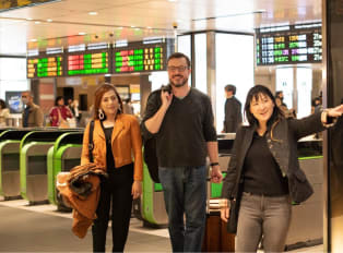 Travelers leaving Kyoto Station with a local host