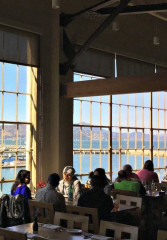 Locals and tourists dining at a waterfront restaurant in San Francisco