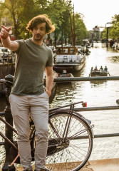 Local guide showing a tourist around Amsterdam on a sunny day