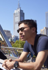 A local guide and tourists on a bridge while touring Melbourne