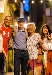 Tourists enjoying a night tour of Barcelona with a local guide