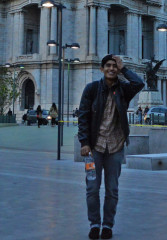 Tourist standing in front of a popular attraction while on a night tour of Mexico City