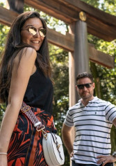 Tourists posing in front of a torii gate at Meiji Jingu Shrine in Shibuya Tokyo