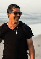 Tourists walking along a Cape Town beach with their local guide