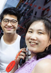 Tourists enjoying a night tour of Hong Kong with a local guide