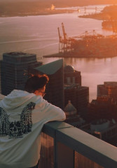 Tourist enjoying the sunset from a viewing platform on a building in Vancouver