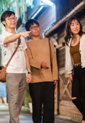 Local guide showing tourists around the city on a night tour of Kyoto