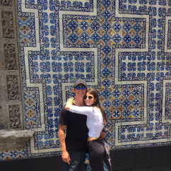 A colorful embrace against iconic tiles