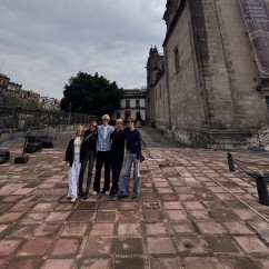 Embracing History: Friends at the Tower's Foot