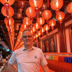 Illuminated Smiles Beneath a Sea of Red Lanterns