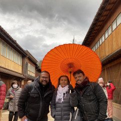 Under the Vibrant Canopy: A Warm Moment Amidst Rainy Skies