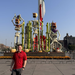 Joyful Visitor Amidst Festive Skeletons