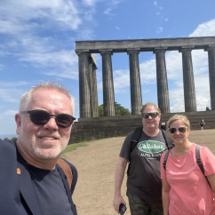 Sunshine and Smiles in Front of Majestic Columns