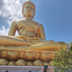 Tourists photographing the huge Buddha statue at Wat Muang.