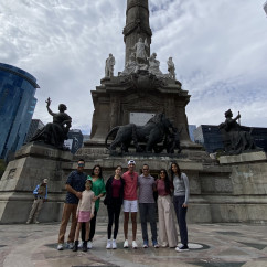 Group of people in front of the Angel of Independence in Mexico City.