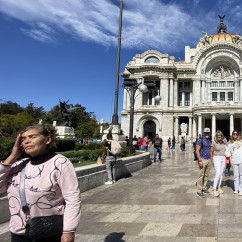 Visitors standing near Palacio de Bellas Artes entrance in Mexico City.