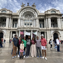Group of people standing in front of Palacio de Bellas Artes, Mexico City.