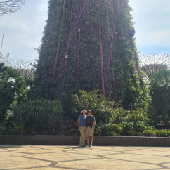 Two people near Supertree Grove in Gardens by the Bay, Singapore.