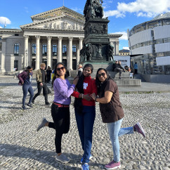 Three women posing in front of the Vienna Opera House, Austria.