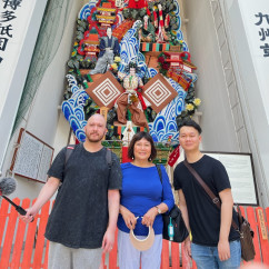 People stand in front of a festival float in Fukuoka, Japan.