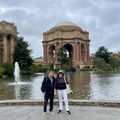 Couple posing near the water at the Palace of Fine Arts, San Francisco.