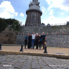 A group of people standing in front of the Virgin of El Panecillo statue, Quito.
