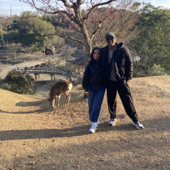 Enjoying a peaceful moment under Nara's blossoming trees.
