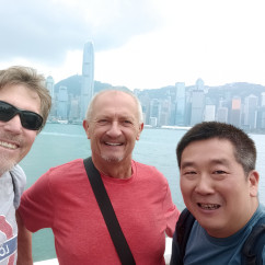 Three men taking a selfie in Hong Kong.