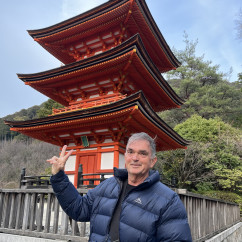 Man standing in front of the three-story pagoda at Kiyomizu-dera, Kyoto.