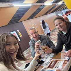 Group sitting at a table with Japanese menus and drinks.