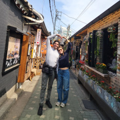 Two people posing on a street in Ikseon-dong, Seoul.