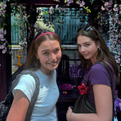 Tourists enjoying a sunny Hong Kong afternoon surrounded by vivid florals.