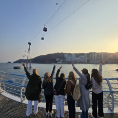 Reaching up to the sky, they embrace the sunset in Busan.