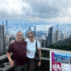 A couple enjoys a breathtaking view over Hong Kong's skyline.