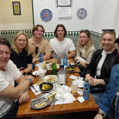 A group savoring traditional bites in a charming Seville corner.