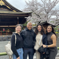 A cheerful group enjoys a cherry blossom moment in Kyoto.