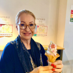 Tourist delighting in a cherry blossom ice cream moment in Osaka.