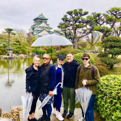 A rainy day adds charm to exploring Osaka Castle's gardens.