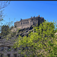 Edinburgh Castle stands majestically against a clear blue sky.