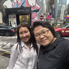 Capturing a cheerful scene against Hong Kong's artistic backdrop.