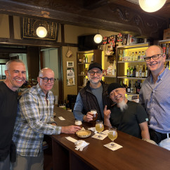 Smiles all around in a cozy Nagasaki bar setting.