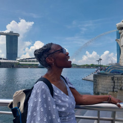 A playful moment with the Merlion's spray in Singapore.