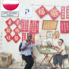 Exploring vibrant street art on a hidden corner in Singapore.