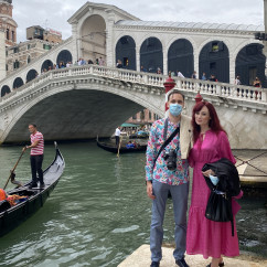 A gondola glides under the iconic Rialto Bridge in Venice.