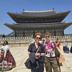 Traditional hanboks bring vibrant colors to the palace courtyard scene.